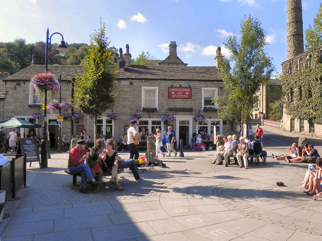 People can be seen sitting in St George's Square in Hebden Bridge enjoying the sunny weather